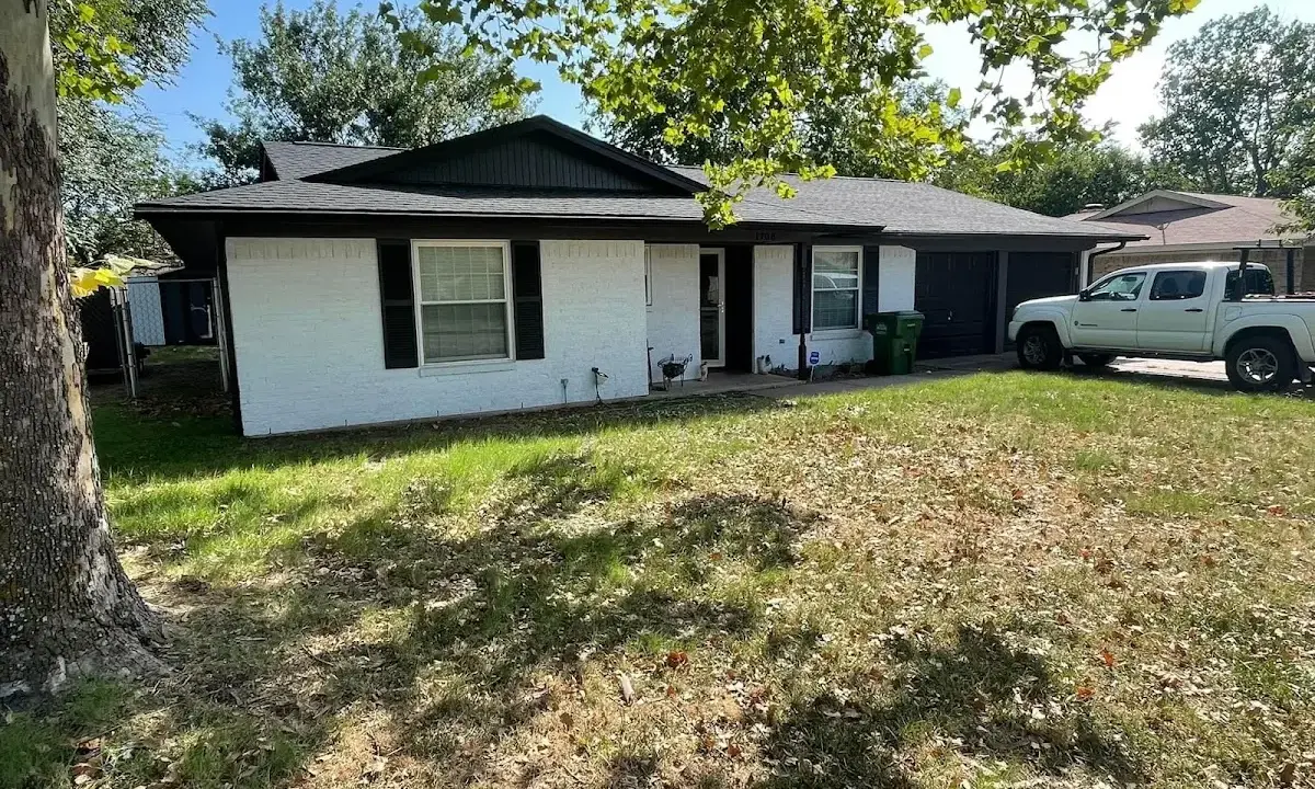 Professional roofing crew working on a residential roof in Blaine